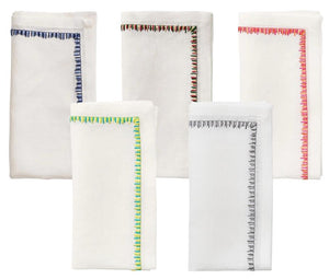 The Filament Napkin Set by Kim Seybert displays five white linen napkins, each with unique embroidered stitching—blue, red, green, black, and multicolored—shown against a white background.