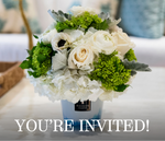 A white and green floral arrangement from Hive Floral Workshop x Baobab Collection by Hive Floral Studio sits in a vase on a table with “YOU’RE INVITED!” overlaid at the bottom.