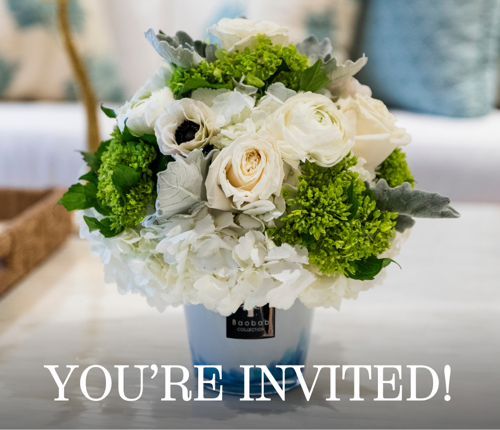 A white and green floral arrangement from Hive Floral Workshop x Baobab Collection by Hive Floral Studio sits in a vase on a table with “YOU’RE INVITED!” overlaid at the bottom.
