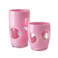 The Mario Luca Giusti Fisheye Acrylic Drinkware Collection features two pink tumblers, one tall and one short, with bold fisheye cutouts—ideal for outdoor table settings.