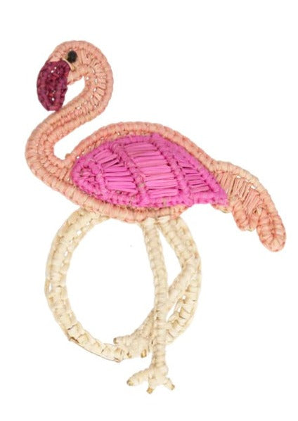 Add a whimsical touch to your table décor with the Mercedes Salazar Flamingo's Party Napkin Ring, featuring a handcrafted woven rattan flamingo with a pink body and beige legs—perfect for festive gatherings.
