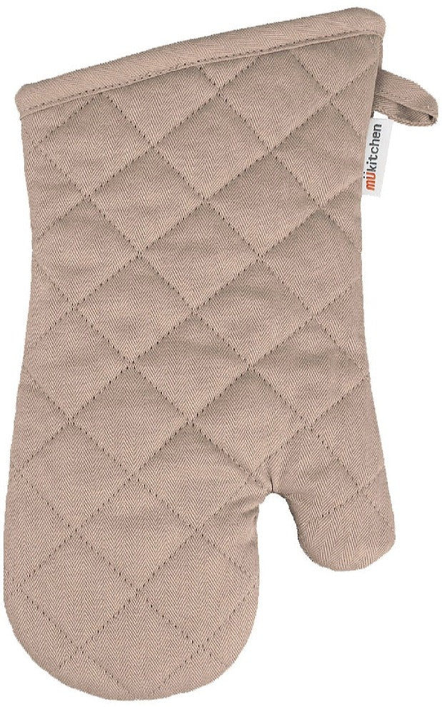 A beige quilted cotton oven mitt from the MUkitchen Oven Mitt Collection, featuring diamond-pattern stitching, a thumb section, soft terry lining for comfort, and a side tag labeled "MUkitchen.