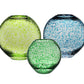 The Globe Vase Collection from William Yeoward Crystal features three round vases in green, yellow-green, and blue with a speckled pattern, presenting a contemporary design against a crisp white background.