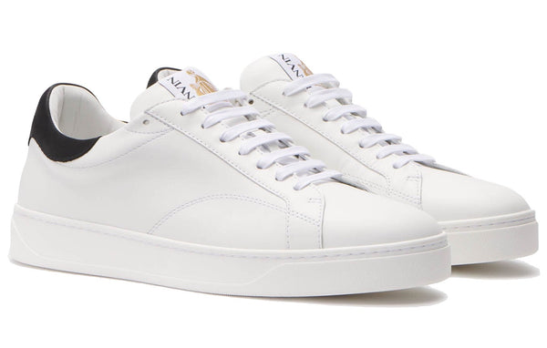 A pair of Lanvin DDB0 Sneakers made from calfskin, featuring black detailing on the heel, white laces, and a thick white sole, placed on a pristine white background.