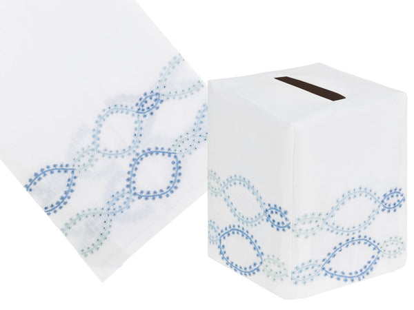 An exquisite Italian linen tissue box cover and matching guest towel from the Foam Bath Collection, Blue by Haute Home feature white fabric adorned with hand-embroidered blue and green oval patterns.