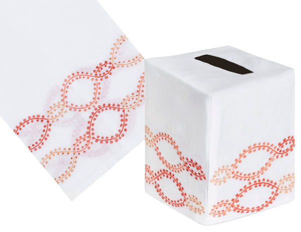 The Haute Home Foam Bath Collection features a coral tissue box cover, skillfully crafted from Italian linen with hand-embroidered red and orange intertwined loops.