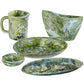 The Nashi Home Serveware Collection, Forest by Nashi Home includes a mug, bowl, small dish, round plate, and oval plate in green and white marbled resin—ideal as stylish serveware or a chic home decor accent.