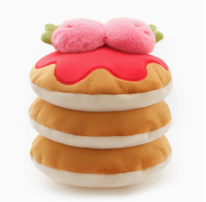 The Foggy Dog's Strawberry Pancake Interactive Dog Toy features a stack of three plush pancakes topped with red syrup and two pink, round strawberry toppings with green accents.