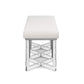 The Lex Bench by Made Goods showcases modern elegance with its sleek silhouette, featuring a rectangular white upholstered cushion and geometric metal legs, all viewed from the front for a display of refined details.