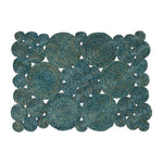 The Francine Placemat by Blue Pheasant features blue and tan woven coils in large and small circles, creating a unique and artistic rectangular design.
