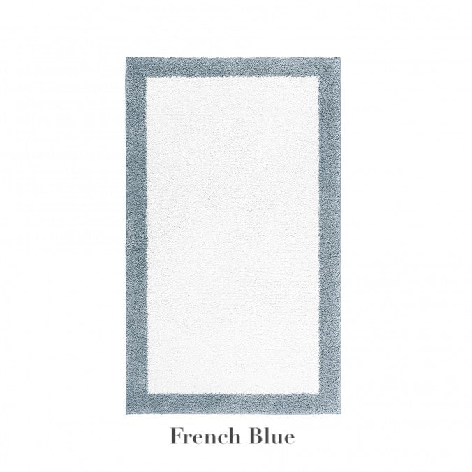 The Egoist Border Bath Rug by Graccioza features a white center with a French blue border and is crafted from luxurious Egyptian cotton. Displayed on a white background with "French Blue" text below the rug.