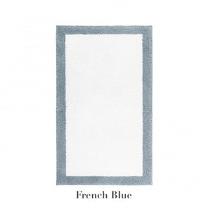The Egoist Border Bath Rug by Graccioza features a white center with a French blue border and is crafted from luxurious Egyptian cotton. Displayed on a white background with "French Blue" text below the rug.