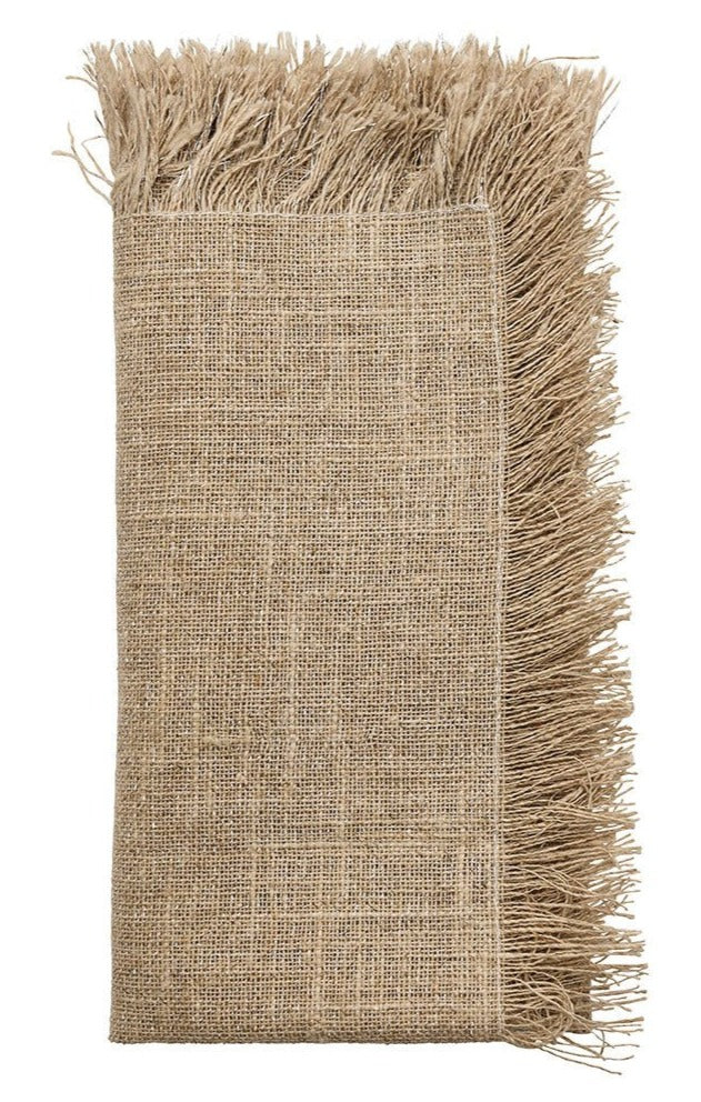 The Kim Seybert Fringe Napkin Set, featuring beige napkins with frayed edges, brings subtle farmhouse chic to your table setting—ideal for adding stylish charm to any occasion.