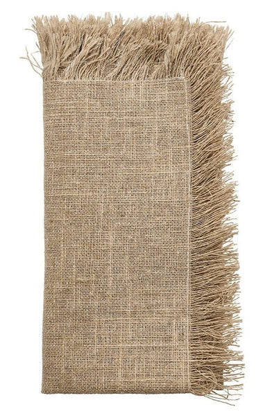 A folded, tan-colored Kim Seybert Fringe Napkin, Set of 4 with fringed edges is shown, featuring a coarse woven texture perfect for a rustic holiday gathering.