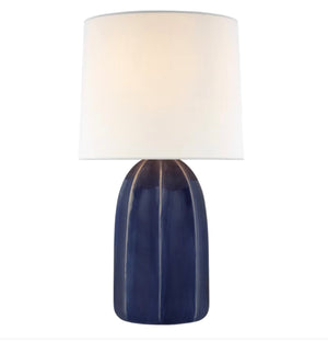 The Melanie Large Table Lamp Collection by Visual Comfort features a glossy dark blue ceramic base with reactive glazes and a white silk shade, offering elegant style against a clean white background.