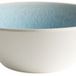 The Jars Vuelta Ocean Blue Collection features a white ceramic bowl with a light blue ocean glaze interior, showcasing timeless elegance against a white background.