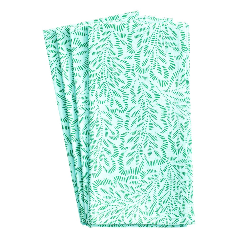 Caspari’s Block Print Leaves Napkin Collection includes three folded cotton napkins featuring a green leafy pattern on white, inspired by traditional Indian textiles.