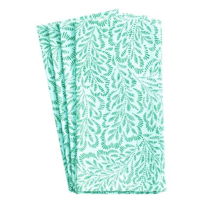 Caspari’s Block Print Leaves Napkin Collection includes three folded cotton napkins featuring a green leafy pattern on white, inspired by traditional Indian textiles.