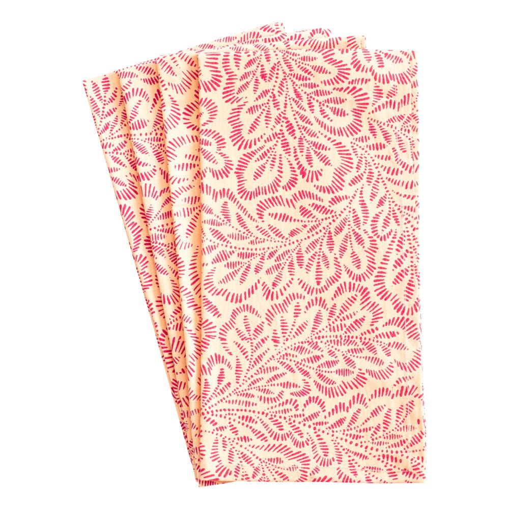 The Caspari Block Print Leaves Napkin Collection features three folded cotton napkins with a red leaf pattern on a light background, inspired by Indian textiles for an elegant table setting.