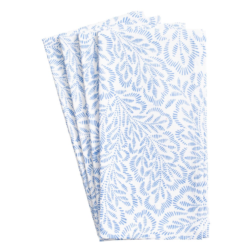The Caspari Block Print Leaves Napkin Collection features three neatly folded white cotton napkins with a repeating blue leaf-like pattern inspired by traditional Indian textiles.