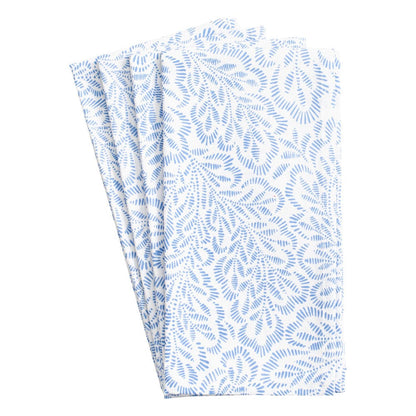 The Caspari Block Print Leaves Napkin Collection features three neatly folded white cotton napkins with a repeating blue leaf-like pattern inspired by traditional Indian textiles.
