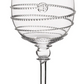 A clear wine glass from the Juliska Amalia Drinkware Collection features a decorative spiral pattern, a small circular motif on the bowl, and intricate details on its thin stem and round base.
