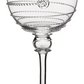 The Amalia Drinkware Collection by Juliska features clear wine glasses with intricate silver wire details and a round silver accent, highlighting the artistry behind each piece.