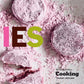 Four round Cookies from Penguin Random House, dusted in pink powdered sugar—with one cookie broken open—sit atop a white surface dusted with more pink powder. Bold, colorful letters spelling “IES” overlay the image, capturing the playful spirit of Cookies you’d expect from a Penguin Random House dessert collection.