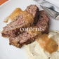 Two slices of meatloaf with brown gravy and a serving of mashed potatoes are arranged on a white plate beside a metal knife. Evocative of the cozy, rich flavors featured in Barefoot Contessa Foolproof by Penguin Random House, this inviting dish promises a satisfying meal. The word “contents” is overlaid on the image.
