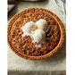 A whole pecan pie topped with three scoops of vanilla ice cream sits on a beige tablecloth next to a plate and spoon, making it the perfect sweet finish to any recipe from Go-to Dinners by Penguin Random House.