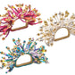 The Kim Seybert Fun Burst Napkin Ring features metallic beads and flexible, curled silicone tubes in pink, white, and blue for a colorful tabletop accent.