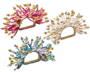 The Kim Seybert Fun Burst Napkin Ring features metallic beads and flexible, curled silicone tubes in pink, white, and blue for a colorful tabletop accent.