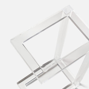 The Clark Acrylic Accent Table by Made Goods features intersecting rectangular frames in clear acrylic, creating a chic geometric sculpture perfect as an accent piece against a white background.