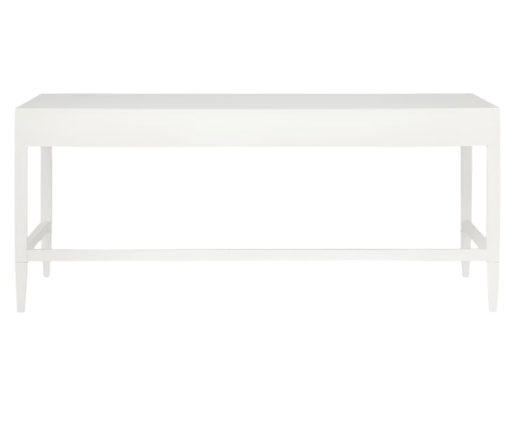 The Conrad Desk by Made Goods is a plain white rectangular table with four straight legs and a flat top, inspired by Chinese console design. At just 14 inches deep, it's ideal for compact spaces and is shown against a white background.