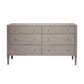 The Conrad Dresser Collection by Made Goods features a rectangular dresser with six drawers in light grey faux raffia, small round brass knobs, and tapered legs—an elegant luxury piece.