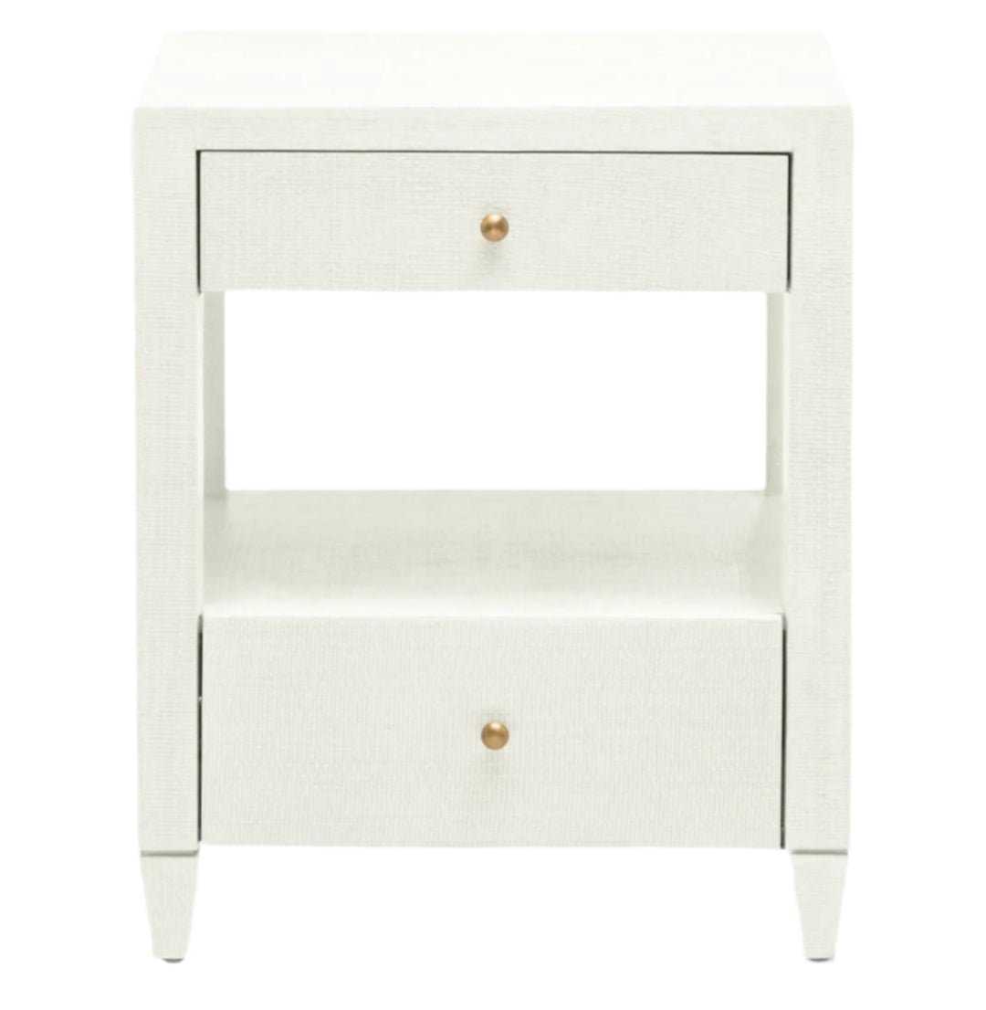 The Made Goods Conrad Nightstand is a white piece with modern proportions, two brass-knob drawers, an open middle shelf, and four short legs.