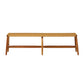 The Corenne Bench by Made Goods features a handcrafted teak frame, loomed fiber rattan seat, four legs, and a minimalist Scandinavian design.