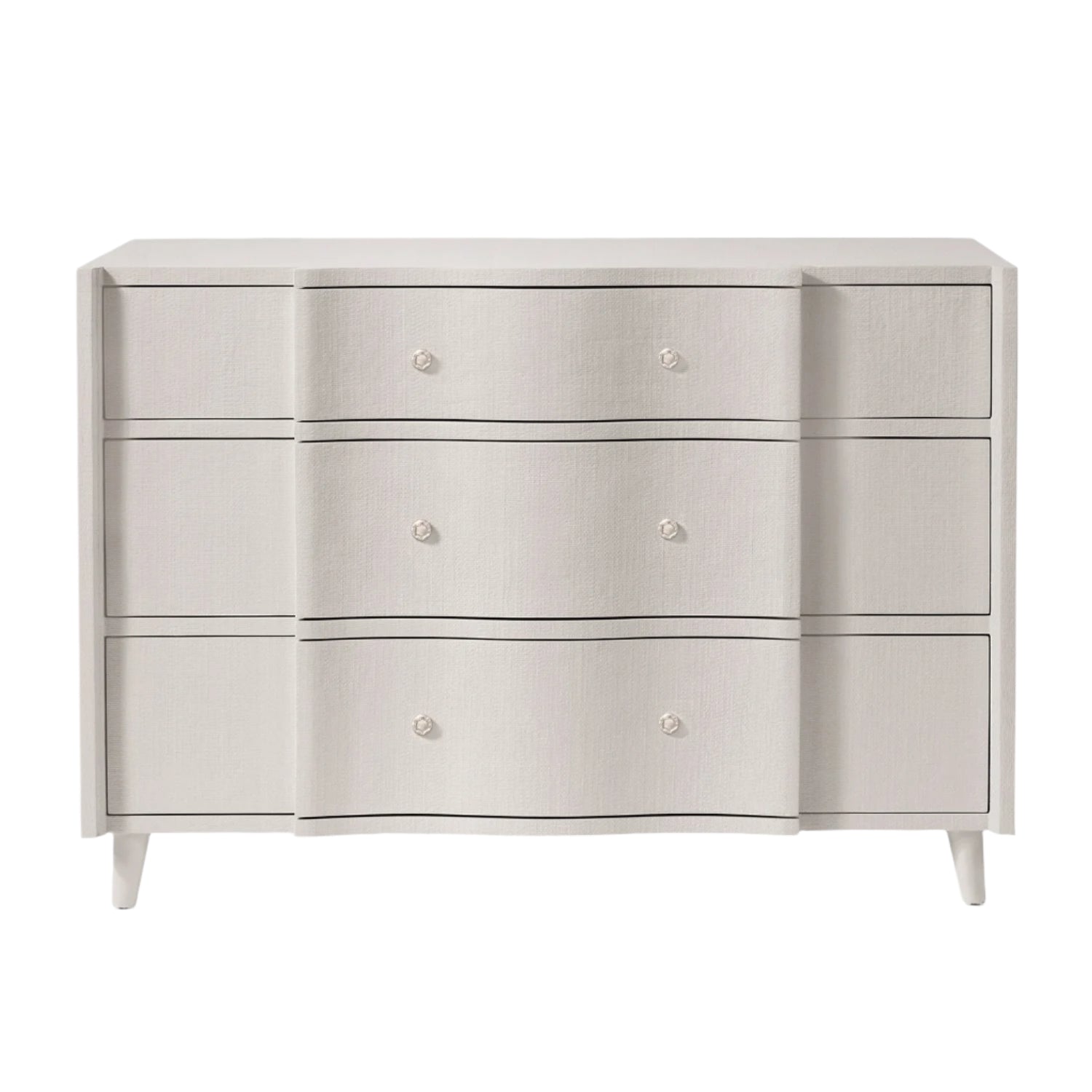 The Essery Dresser Collection by Made Goods features a white six-drawer dresser with a scalloped front and custom hardware inspired by the brand’s signature design.