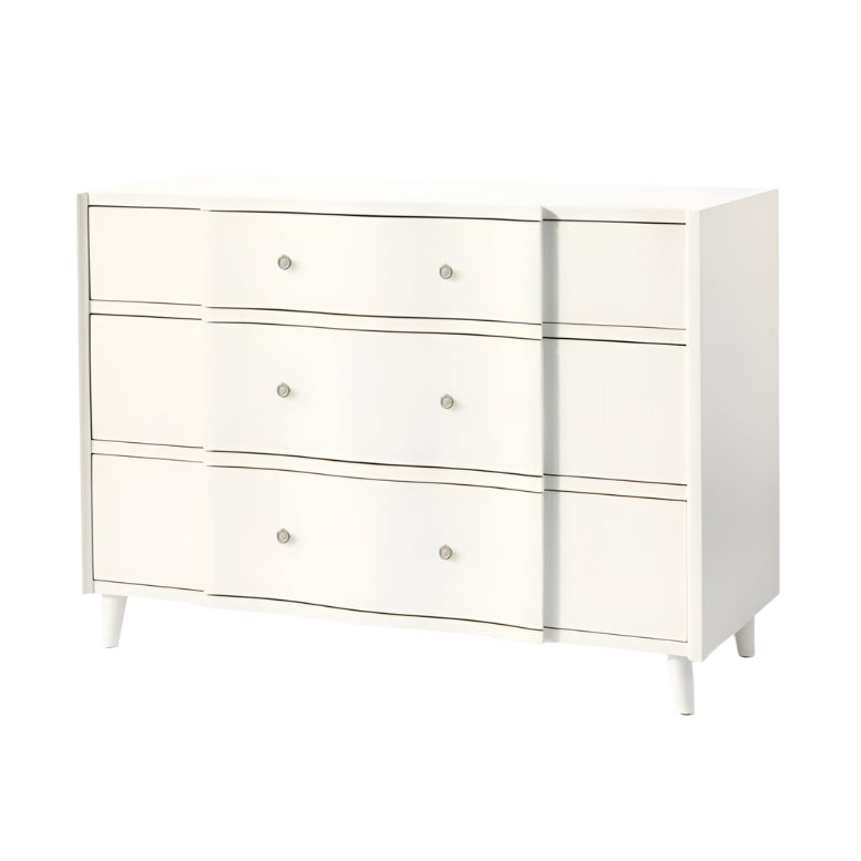 The Essery Dresser Collection by Made Goods features a white three-drawer dresser with round silver knobs, gently curved fronts, four short legs, and soft-close glides for a modern touch.