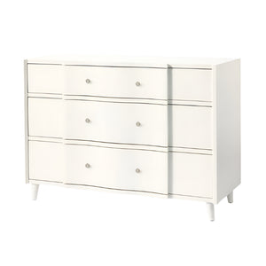 The Essery Dresser Collection by Made Goods features a white three-drawer dresser with round silver knobs, gently curved fronts, four short legs, and soft-close glides for a modern touch.