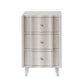 Front view of a light gray, three-drawer nightstand from the Essery Nightstand Collection by Made Goods, featuring faux raffia texture, round knobs, and tapered legs—a stylish transitional accent for any room.