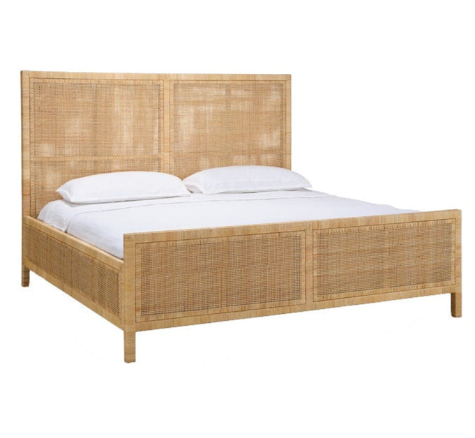 A Made Goods Isla Bed Collection bed features a high rectangular handwoven rattan frame, white bedding, and two pillows.