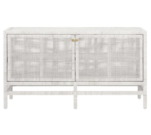 The Isla Buffet by Made Goods is a white, rectangular sideboard with rattan-cane doors, vertical legs, and brass handles—an elegant choice for dining rooms—shown against a plain background.