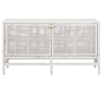 The Isla Buffet by Made Goods is a white, rectangular sideboard with rattan-cane doors, vertical legs, and brass handles—an elegant choice for dining rooms—shown against a plain background.