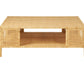 The Isla Coffee Table by Made Goods is a rectangular rattan piece with a lower shelf and two woven side panels, shown against a white background.