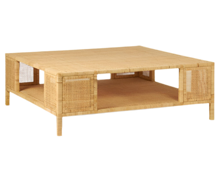 The Isla Coffee Table by Made Goods is a square, light-colored rattan piece featuring open shelving on each side, a lower storage shelf, and short legs.