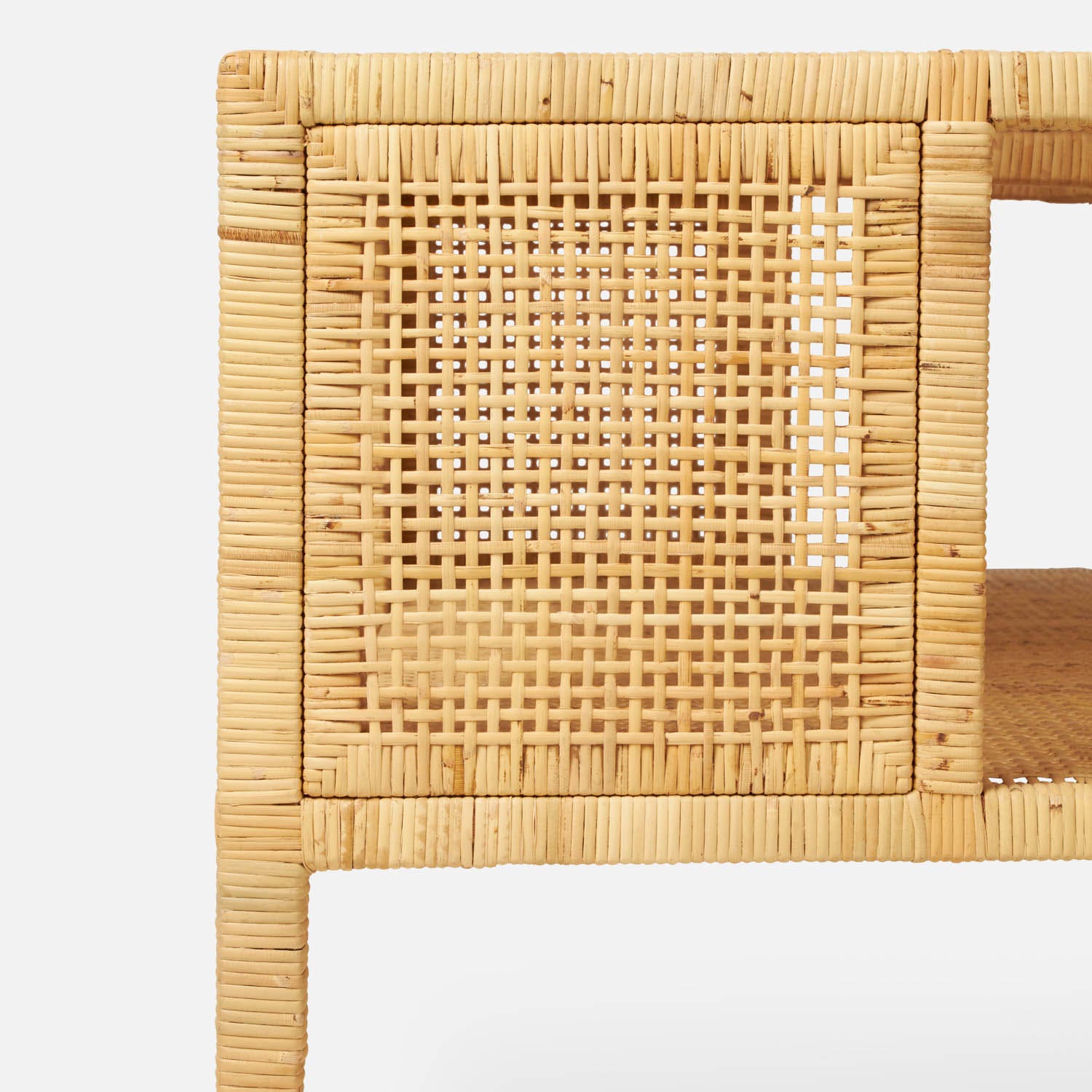 Close-up of the Isla Coffee Table by Made Goods, showcasing its woven wicker panel design, natural wood finish, and an extra lower shelf, all set against a white background.