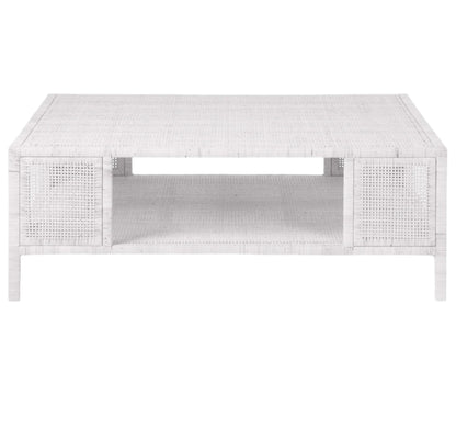 The Isla Coffee Table by Made Goods features a rectangular white rattan design with an open lower shelf, displayed against a plain white background.