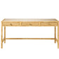 The Isla Desk by Made Goods is a rectangular wooden piece with a rattan frame, woven basket weave finish, and three front drawers accented with small round knobs.