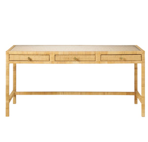 The Isla Desk by Made Goods is a rectangular wooden piece with a rattan frame, woven basket weave finish, and three front drawers accented with small round knobs.